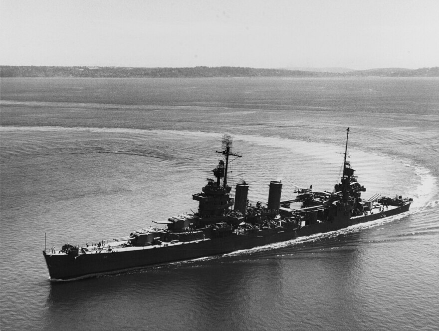 The U.S. Navy heavy cruiser USS New Orleans (CA-32) steams through a tight turn in Elliot Bay, Washington, on July 30, 1943, following battle damage repairs and overhaul at the Puget Sound Naval Shipyard.