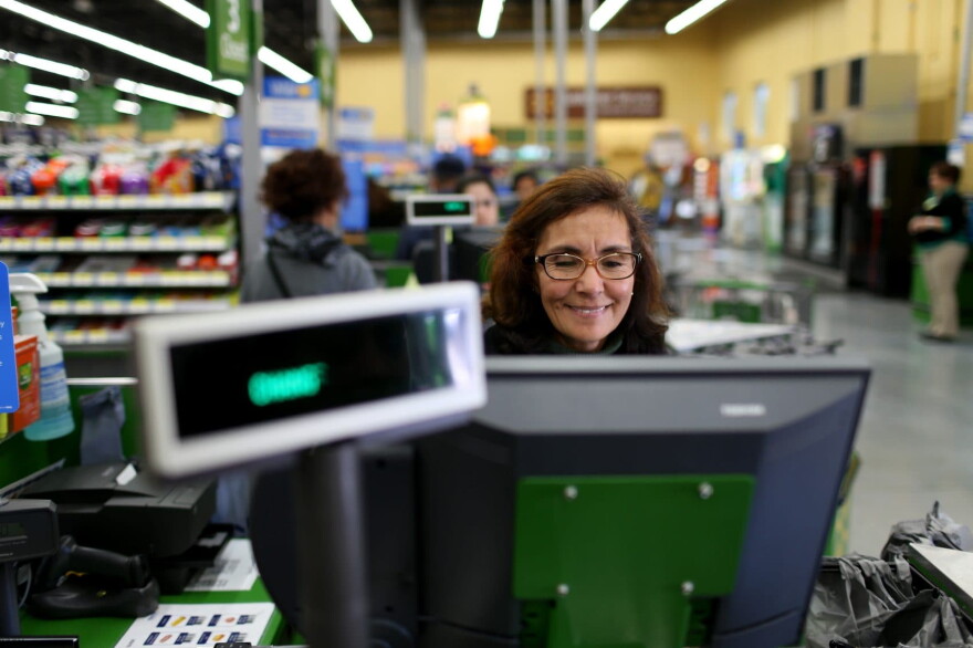 Wal-Mart employee Blanca Mojita rings up a customer's purchases at a Wal-Mart store on Feb. 19, 2015 in Miami. (Joe Raedle/Getty Images)