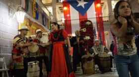 A musical group playing traditional Puerto Rican bomba music performs at a parranda in Hartford, Conn.