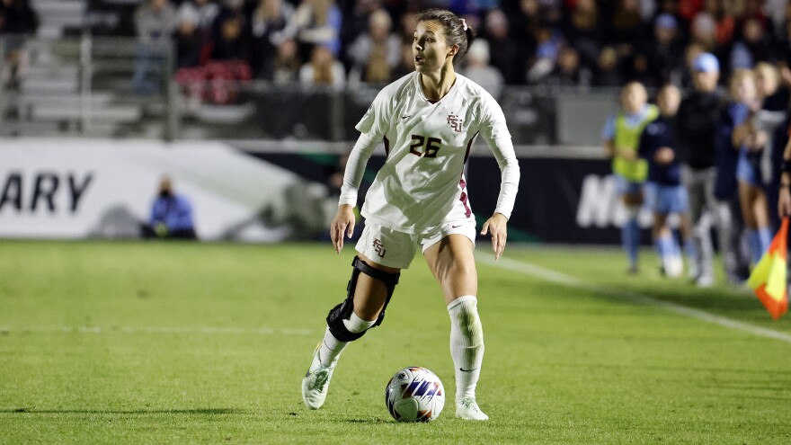 Florida State's Clara Robbins (26) looks to pass the ball against North Carolina during the second half of the NCAA women's soccer tournament semifinal match in Cary, N.C., Friday, Dec. 2, 2022. (AP Photo/Karl B DeBlaker)