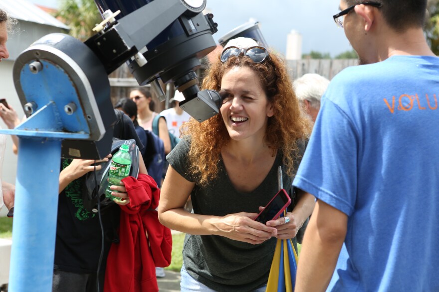 Shahar Maron delights in the view of the eclipse through a protected telescope at the Campus Teaching Observatory on Monday. “It feels like a once-in- a-lifetime experience,” said the UF human performance graduate student. (Emma Green/WUFT News)