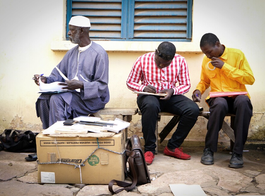 Getting postcards from Timbuktu, Mali, to destinations around the world is a lengthy process. Daba Traoré, center, takes the postcards — which have been flown in from Timbuktu on a U.N. plane — to the central post office in Bamako.