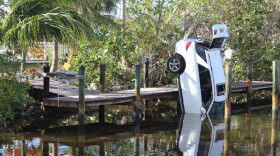 A neighbor’s car was swept into the canal behind Chase Hussey and Erica Racz’s Fort Myers Beach home.