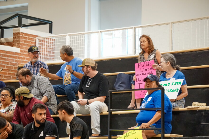 Community members hold their signs, demonstrating their frustration with the data center.