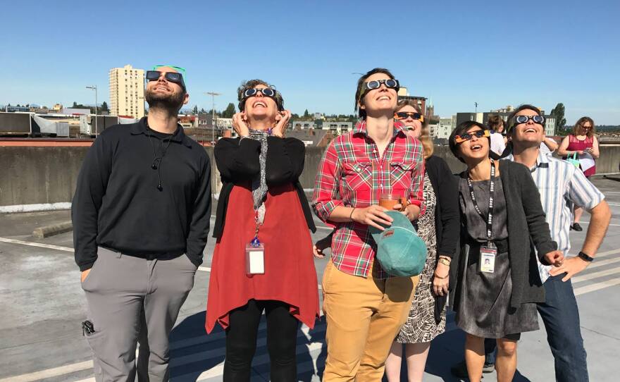 KUOW staff gathered on the garage roof to watch the eclipse. From left, Matt Albertson, Marcie Sillman, Elizabeth Hovance, Carol Smith, Ruby de Luna, Joshua McNichols.
