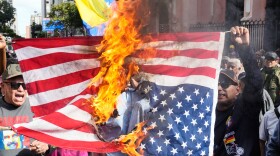 Government supporters burn a U.S. flag in Caracas, Venezuela, Saturday, Jan. 3, 2026, after U.S. President Donald Trump announced that U.S. forces had captured Venezuelan President Nicolás Maduro and his wife.