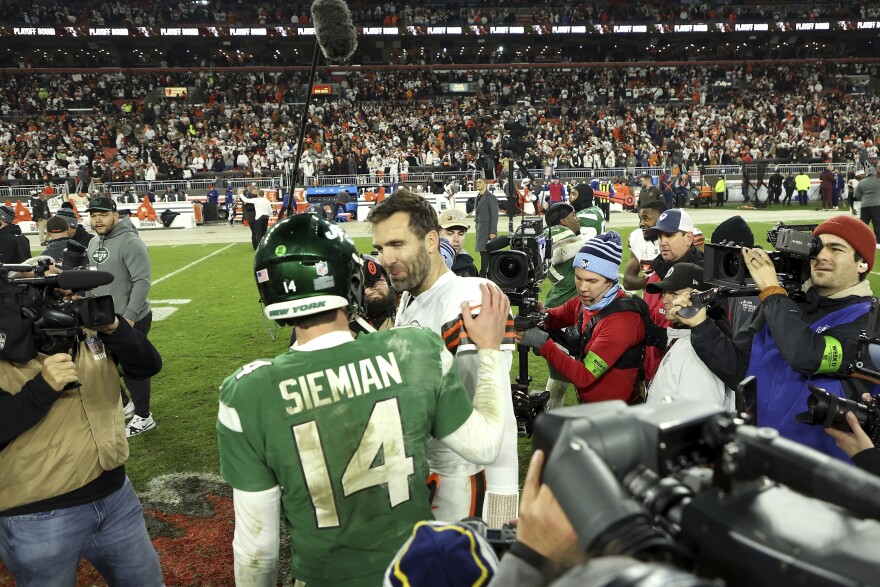 New York Jets quarterback Trevor Siemian (14) talks with Cleveland Browns quarterback Joe Flacco (15) after an NFL football game, Thursday, Dec. 28, 2023, in Cleveland. (AP Photo/Kirk Irwin)
