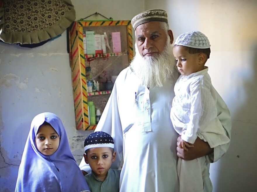 Gul Mohammed Khan has lost three sons in sectarian violence during the last two years, in Karachi, Pakistan. He stands here with some of his grandchildren who have lost their fathers. When he looks at his grandchildren, he says, he sees his sons.