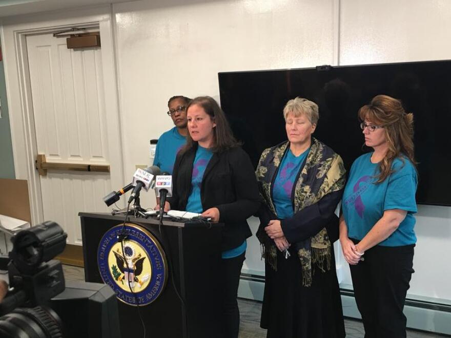 Jolie Moran (center) with representatives from a local survivors network. TOM MAGNARELLI / WRVO PUBLIC MEDIA
