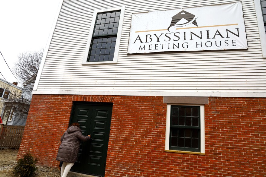 Pam Cummings leaving the Meeting House after giving to tour to Congresswoman Chellie Pingree and her staff.