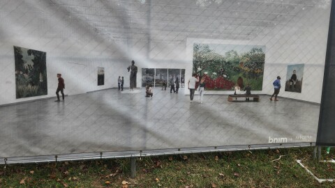 A rendering of a space in the renovated Springfield Art Museum hangs on a fence surrounding construction in November 2025.
