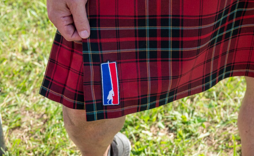 Logo for caber toss that looks like the NBA logo.