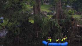 Rescue workers are seen a boat as they search for missing people near Camp Mystic along the Guadalupe River after a flash flood swept through the area Sunday, July 6, 2025, in Hunt, Texas. (Julio Cortez/AP)