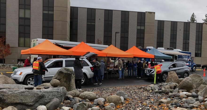 Vehicles carrying veterans and their family members stop at a staging area next to Spokane's VA Medical Center to receive free food donations from Second Harvest and other services on Veterans' Day.