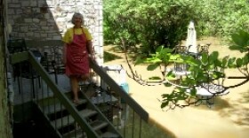 Pat Greer of Frankfort inspects her flooded patio.