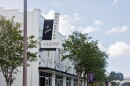 White building with black and white sign reading the historic Manhattan Casino with trees around it 