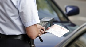 officer writing parking ticket