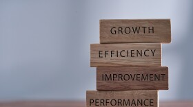Business management related words growth, efficiency,improvement and performance on wooden blocks