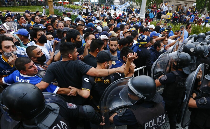 Police block soccer fans waiting to see Diego Maradona lying in state in Buenos Aires on Thursday.