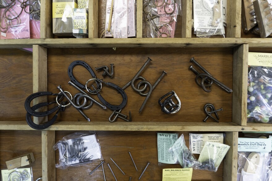 In addition to wooden toys, the Mountain Craft Shop Co. also sells metal puzzles and cloth dolls.
