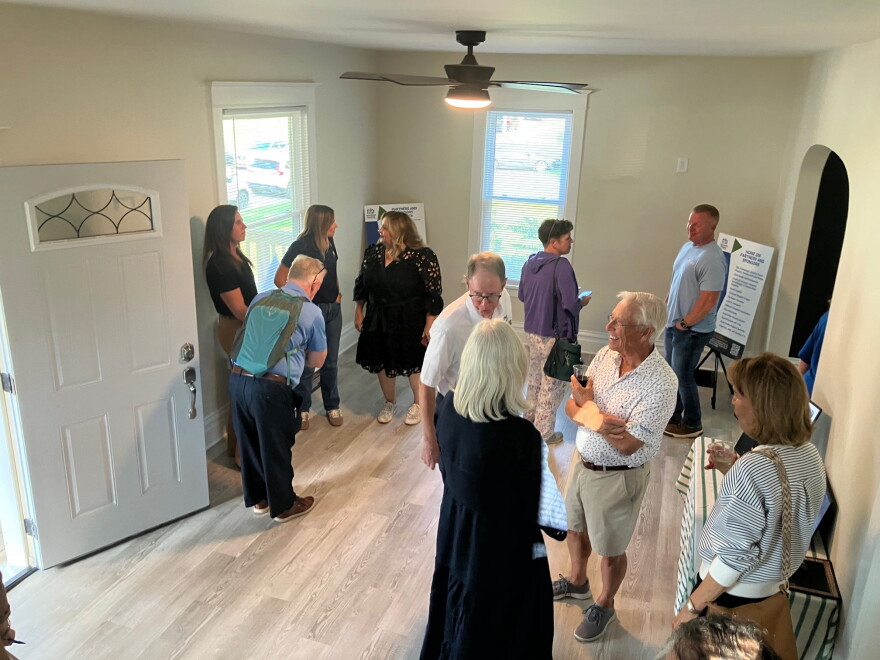 Attendees of Tuesday's open house in the living room of the renovated home.