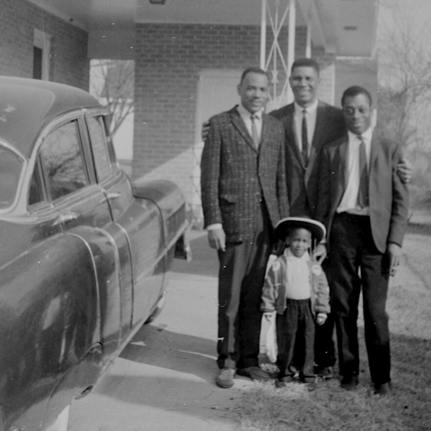Medgar Evers embraces friends James Meredith (left), the first black student to enroll in the University of Mississippi (with Evers' help), and iconic writer James Baldwin (right), who covered the civil rights movement for magazines like <em>The New Yorker</em>. Van Evers stands in front: "It's one of the very few photos I have of my dad and me," he says.