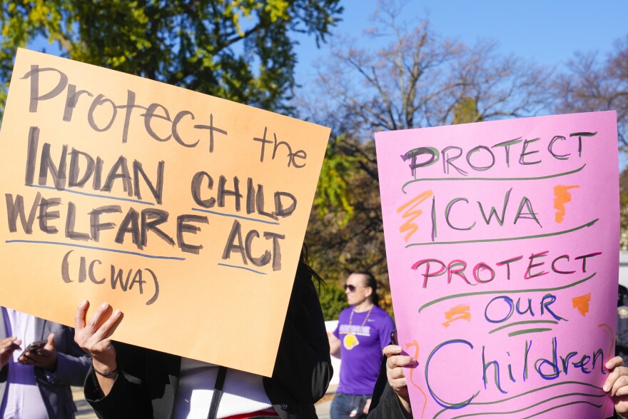 FILE - Demonstrators stand outside the U.S. Supreme Court in Washington, Nov. 9, 2022, as the court hears arguments over the Indian Child Welfare Act. North Dakota's Republican Gov. Doug Burgum has signed a bill into law to protect tribal cultures by codifying the federal Indian Child Welfare Act into state law, Burgum's office announced Monday, May 8, 2023.