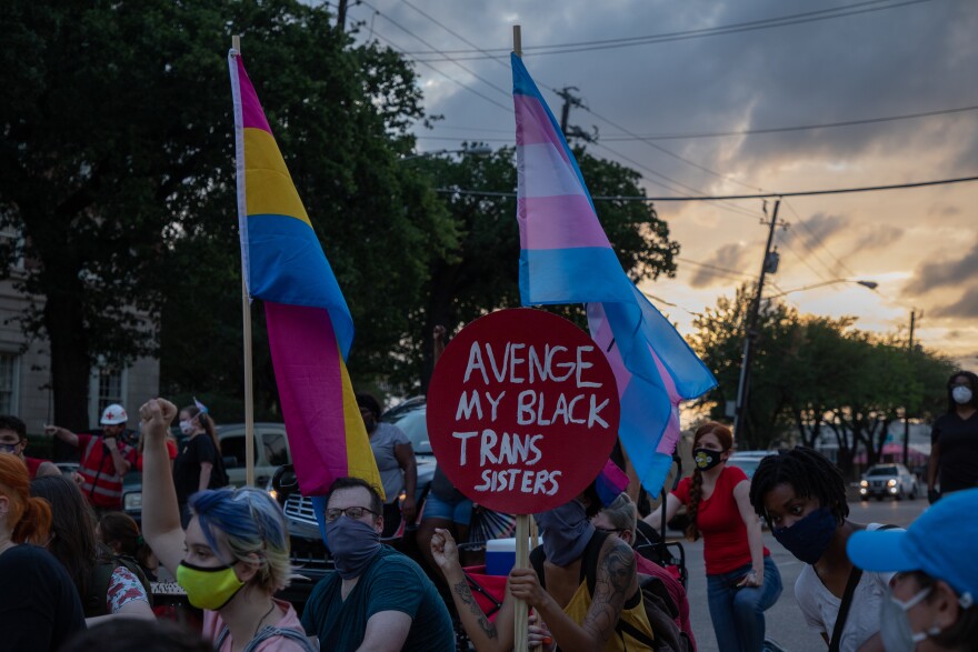 A sign at a demonstration says "Avenge my Black trans sisters"