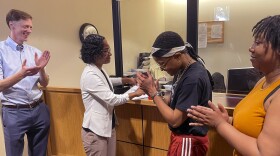 From left, New Haven Mayor Justin Elicker, Wildaliz Bermudez, Executive Director of the Fair Rent Commission, Annie hardy and Amanda Watts react after signing notarized papers to form a tenant union. 
