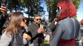 A woman who identified herself only as "Julie from east Multnomah County" exchanges opinions with local drag performer Emma Scott Lavin, who performs under the name "We Are Belov3d" outside Old Nick's Pub Sunday. Their exchange was one of the calmer ones seen during the protest and counterprotest.