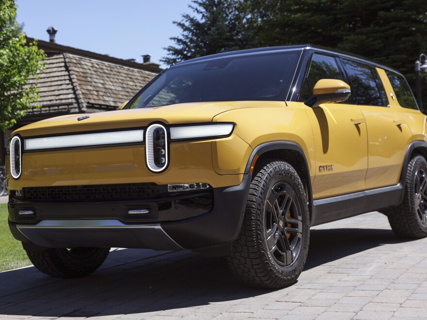 Rivian says its R1S SUV, seen here, will continue to qualify for a tax credit for electric cars, after it was left off an initial list from the IRS. However, a price cap requirement will be a barrier for most purchasers: Only a bare-bones version of the premium electric SUV squeaks under the $80,000 price cap.