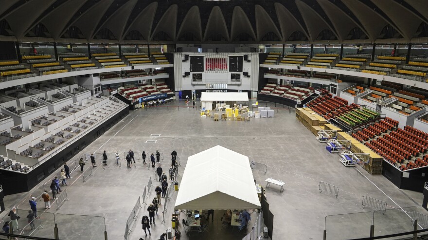 People queue to be tested for the coronavirus in a sports arena on Tuesday in Lyon, France. The World Health Organization said there were more than 700,000 new coronavirus cases reported in Europe last week.
