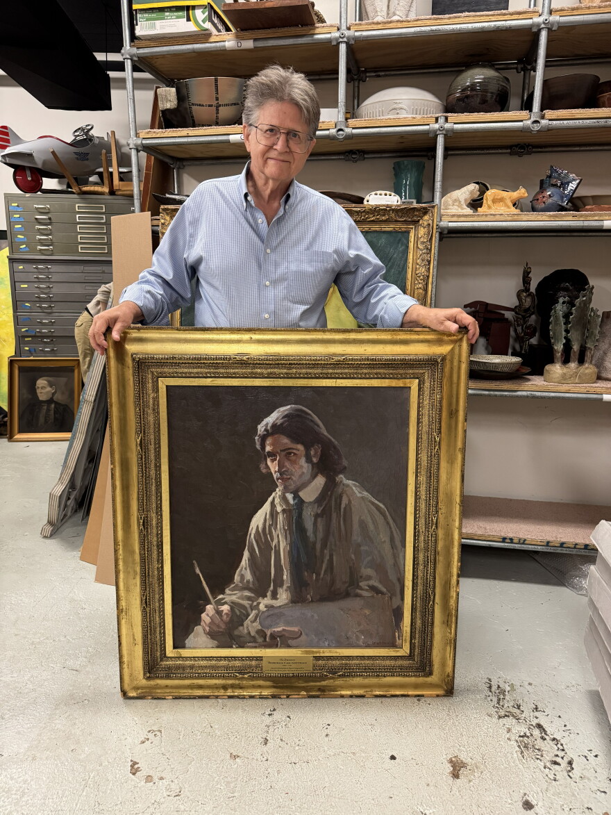 Grafton Nunes, the new executive director of the Cleveland Artists Foundation, showed off a painting by Frederick Gottwald, called “The Dreamer,’’ in the organization’s former storage space at the West 78th Street Studios.