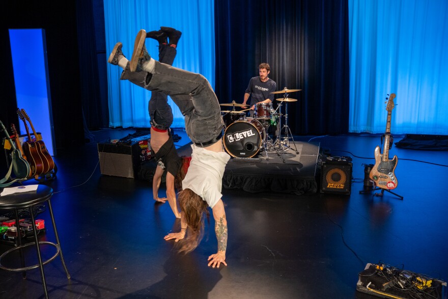 C-Level members doing handstands during a performance at the Idea Center
