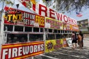 FILE - In this July 2, 2013, file photo, a family purchases fireworks at a TNT Fireworks stand in the City of Monterey Park, Calif. (AP Photo/Nick Ut, File)