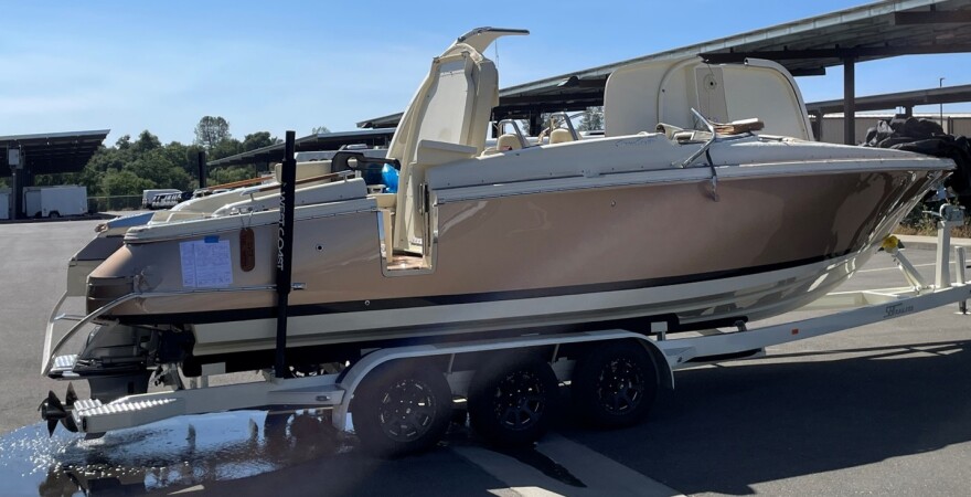A boat out of the water and on a trailer.