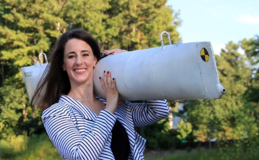 Scientist Rachel Lance poses with a replica she created of  the H.L. Hunley submarine.