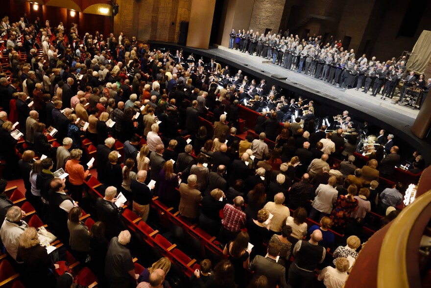 The Metropolitan Opera and Orchestra performs the French National Anthem during the matinee performance of Puccini's <em>Tosca</em>, in New York.