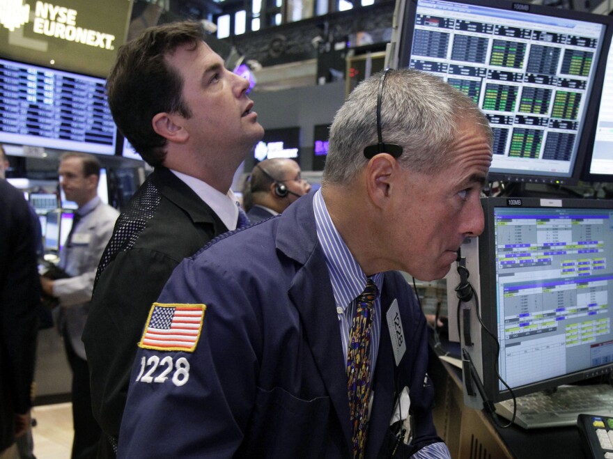 Traders work on the floor of the New York Stock Exchange. The Dow Jones industrial average is nearly back to where it was before the recession hit in 2007.