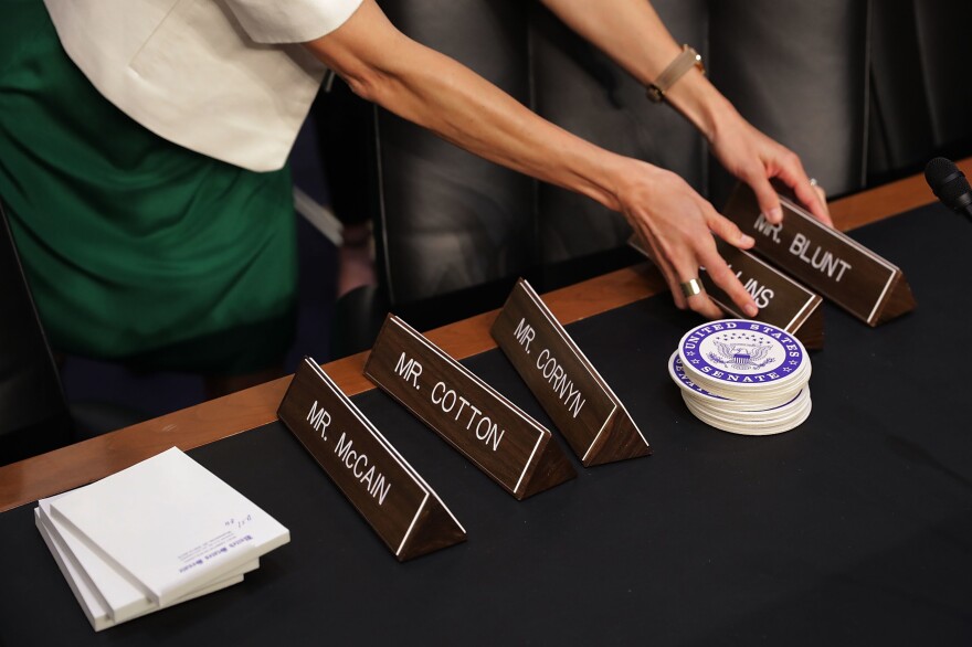 Senate Intelligence Committee staff prepare the the room for a hearing with former FBI Director James Comey on Capitol Hill on Thursday.