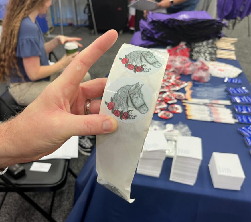 Secretary of State Michael Adams holds the winning design from the 2025 “I Voted” sticker contest.