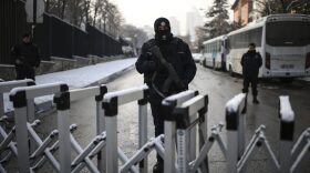 A Turkish police officer secures the road leading to the Russian embassy in Ankara, Turkey, Wednesday, Dec, 21, 2016. Russian Ambassador to Turkey, Andrei Karlov, was assassinated Monday by a police officer during the opening of a photo exhibition. (Emrah Gurel/AP)