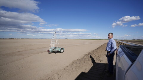 FILE - Tom Brundy looks over his field that is being prepared for planting near Calexico, Calif., Feb. 28, 2023.