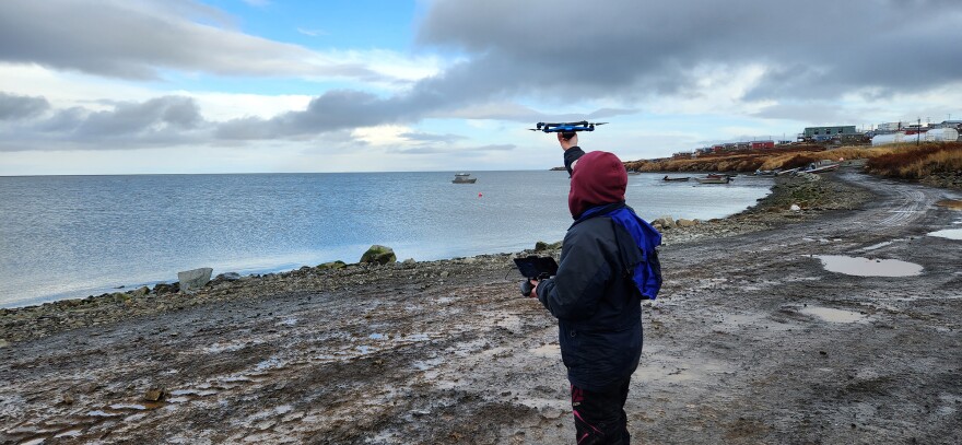 Photo by Mike DeLue Pilot Katie Daniels, with the Association of Village Council Presidents, launches a Skydio drone over the community of Mertarvik on Oct. 20, 2022.