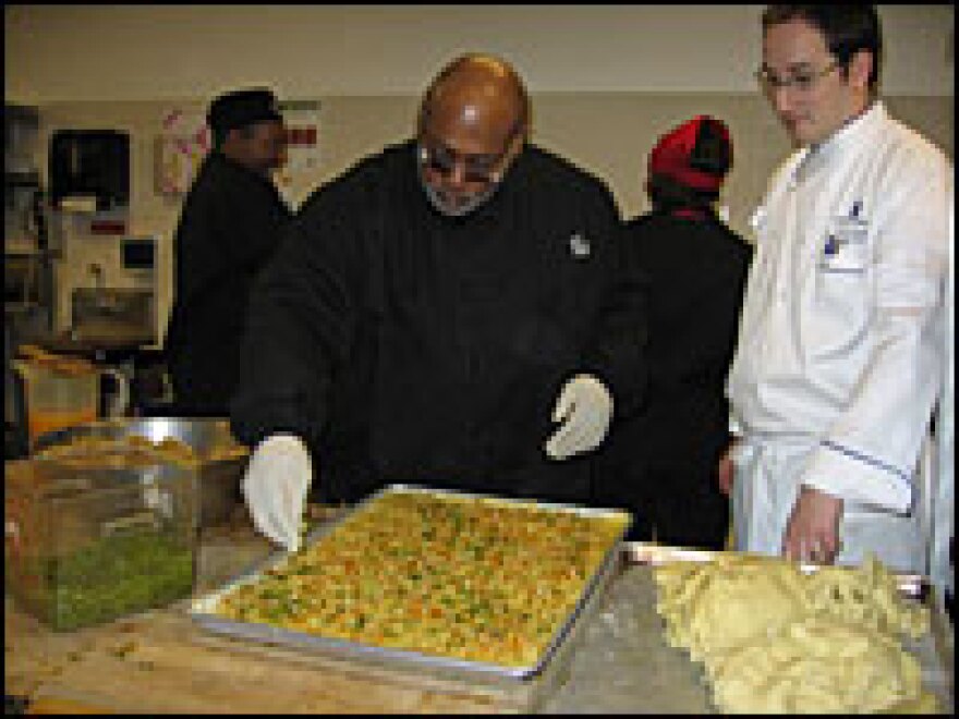 Curtis Cunningham prepares Michelle Obama's cookie recipe as chef Jerome Girardot watches and provides advice.  About 8,000 cookies will be made.