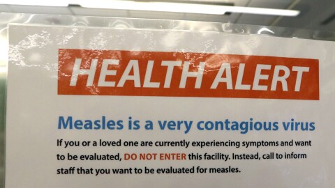 A notice for a health alert about measles is posted on the door of a medical facility Wednesday, Feb. 13, 2019, in Seattle. A recent measles outbreak has sickened more than 50 people in the Pacific Northwest, most in Washington state and, of those, most are concentrated in Clark County, just north of Portland, Oregon. Washington Gov. Jay Inslee declared a state of emergency over the outbreak last month. (AP Photo/Elaine Thompson)