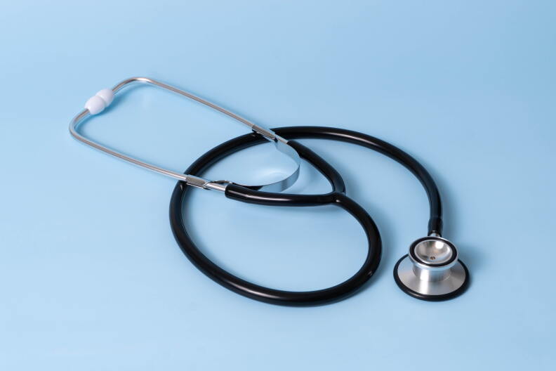 Stethoscope on light blue background