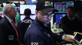 A trader wears a hat reading Dow 23,000 on the floor of the New York Stock Exchange (NYSE) on Oct. 17, 2017 in New York City. (Spencer Platt/Getty Images)