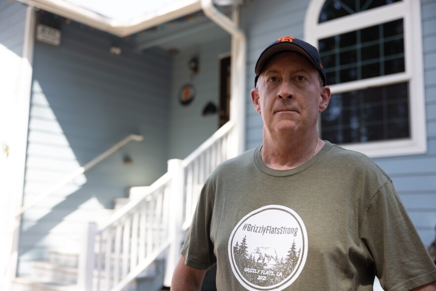 Mark Almer poses outside his Grizzly Flats home.