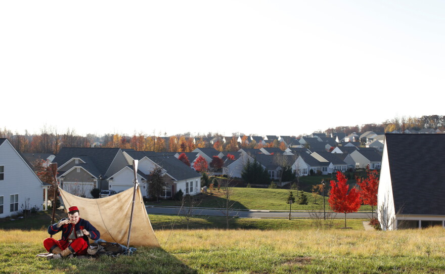 Federal Zouave Prillaman brushes his teeth where there was once a winter encampment of the Army of the Potomac, in Stafford County, Va. Several Union Zouave regiments, which wore colorful, French North African-influenced uniforms, camped here.